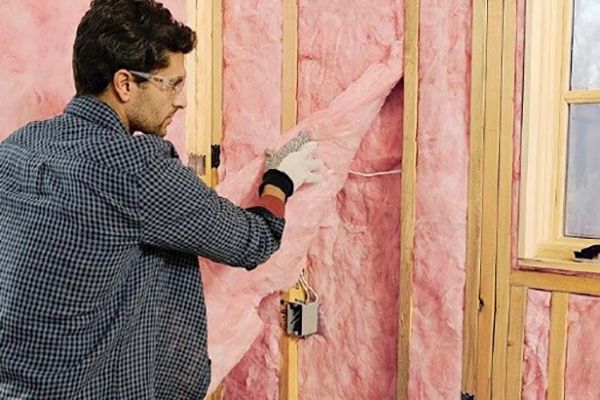 Skilled worker applying closed cell spray foam insulation to a home's walls, creating an airtight and energy-efficient seal.