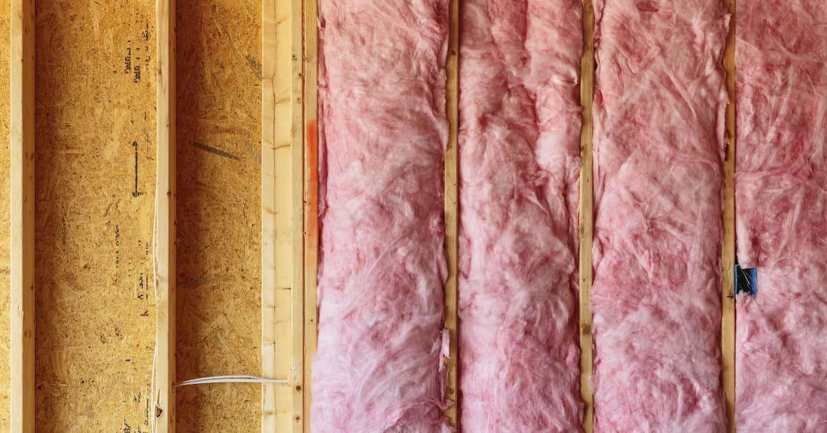 Closed cell spray foam insulation applied to the exterior walls of a home, forming a seamless and energy-efficient barrier.