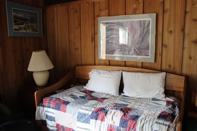 There is a picture on the wall above the bed.