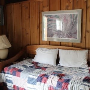 There is a picture on the wall above the bed.