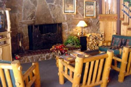 A living room with wooden furniture and a fireplace