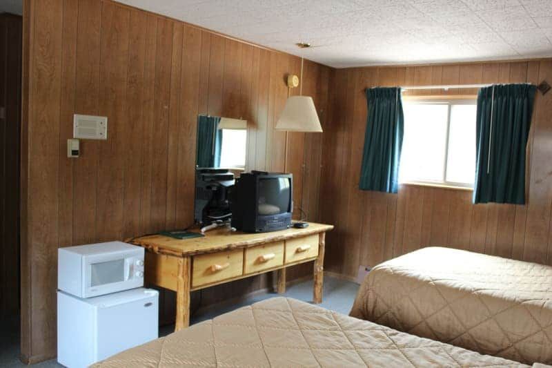 A hotel room with two beds and a microwave