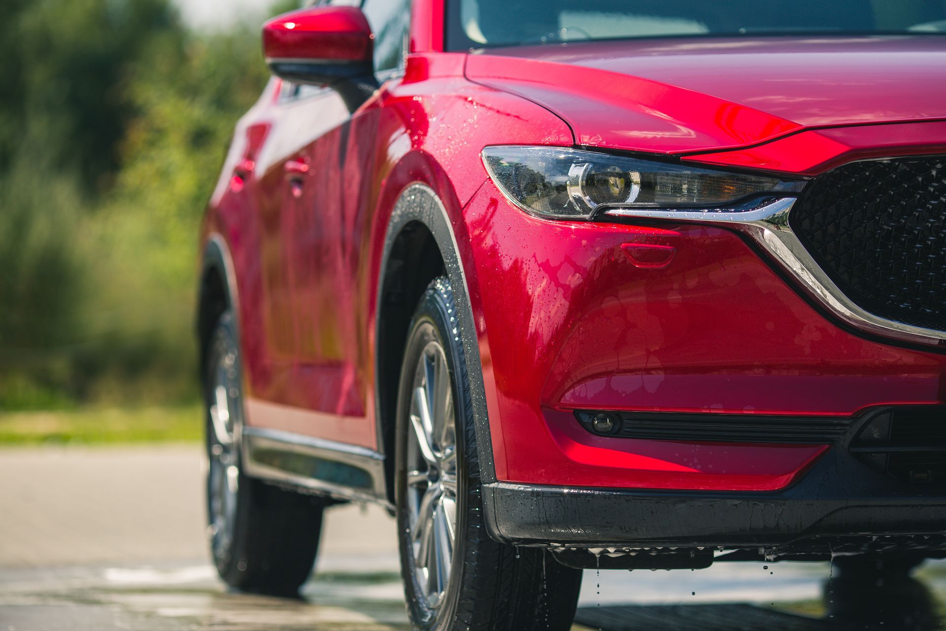 A red car is parked on the side of the road.