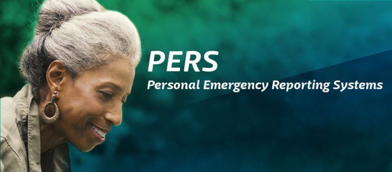 A woman with gray hair is smiling in front of a sign that says pers personal emergency reporting systems.