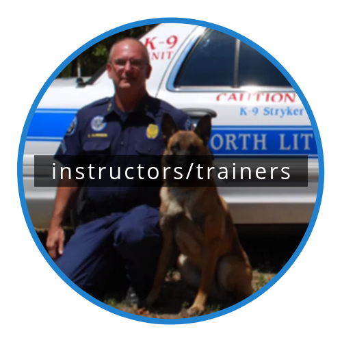 Police trainer with a German shepherd beside a marked K-9 vehicle, labeled “instructors/trainers”