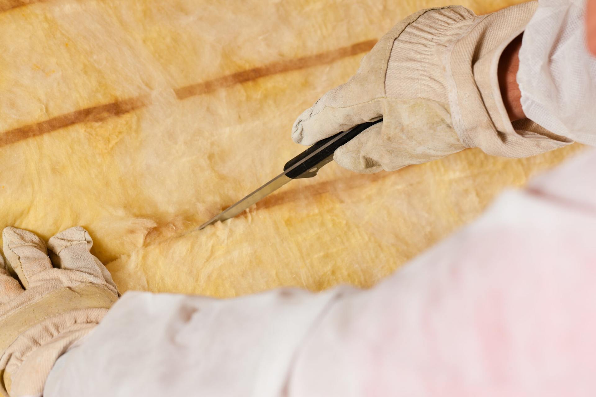 Man cutting the Material — Insulation Repair in Northbrook, IL