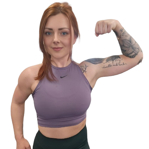 A woman in a black bra and green pants is flexing her muscles.