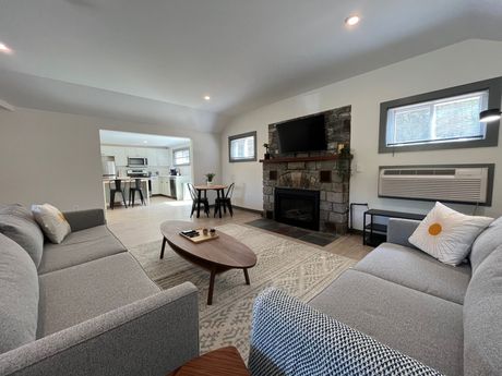 A living room with two couches , a coffee table , and a fireplace.