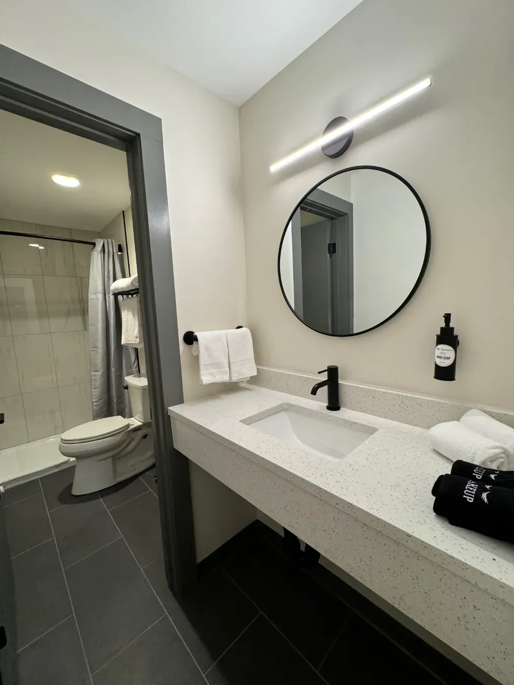 A bathroom with a sink , toilet , and mirror.