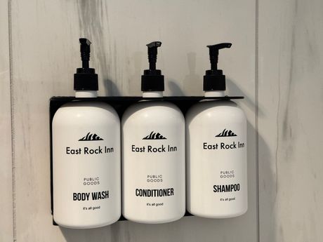 Three bottles of east rock inn shampoo conditioner and body wash