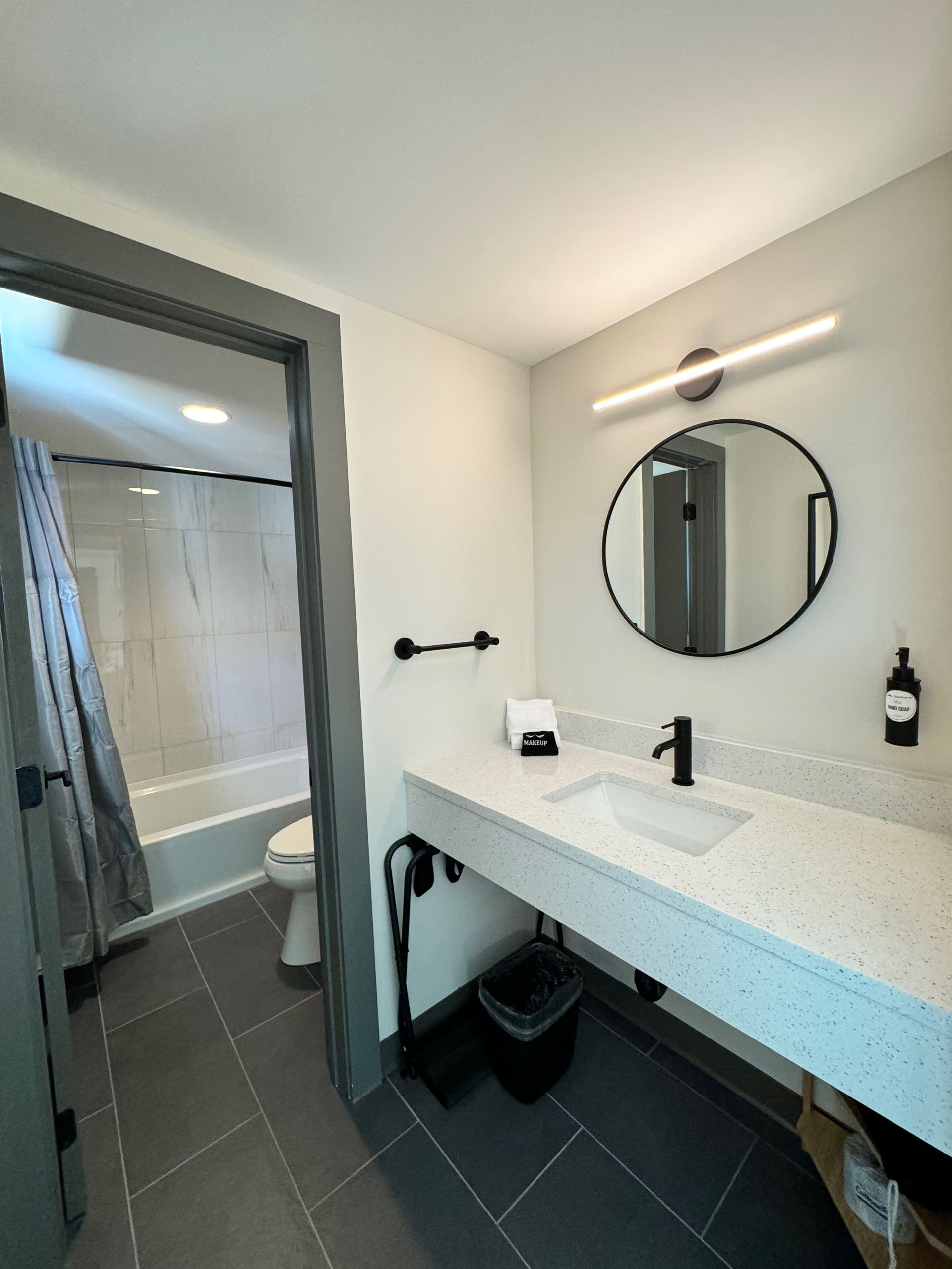 A bathroom with a sink , toilet , and mirror