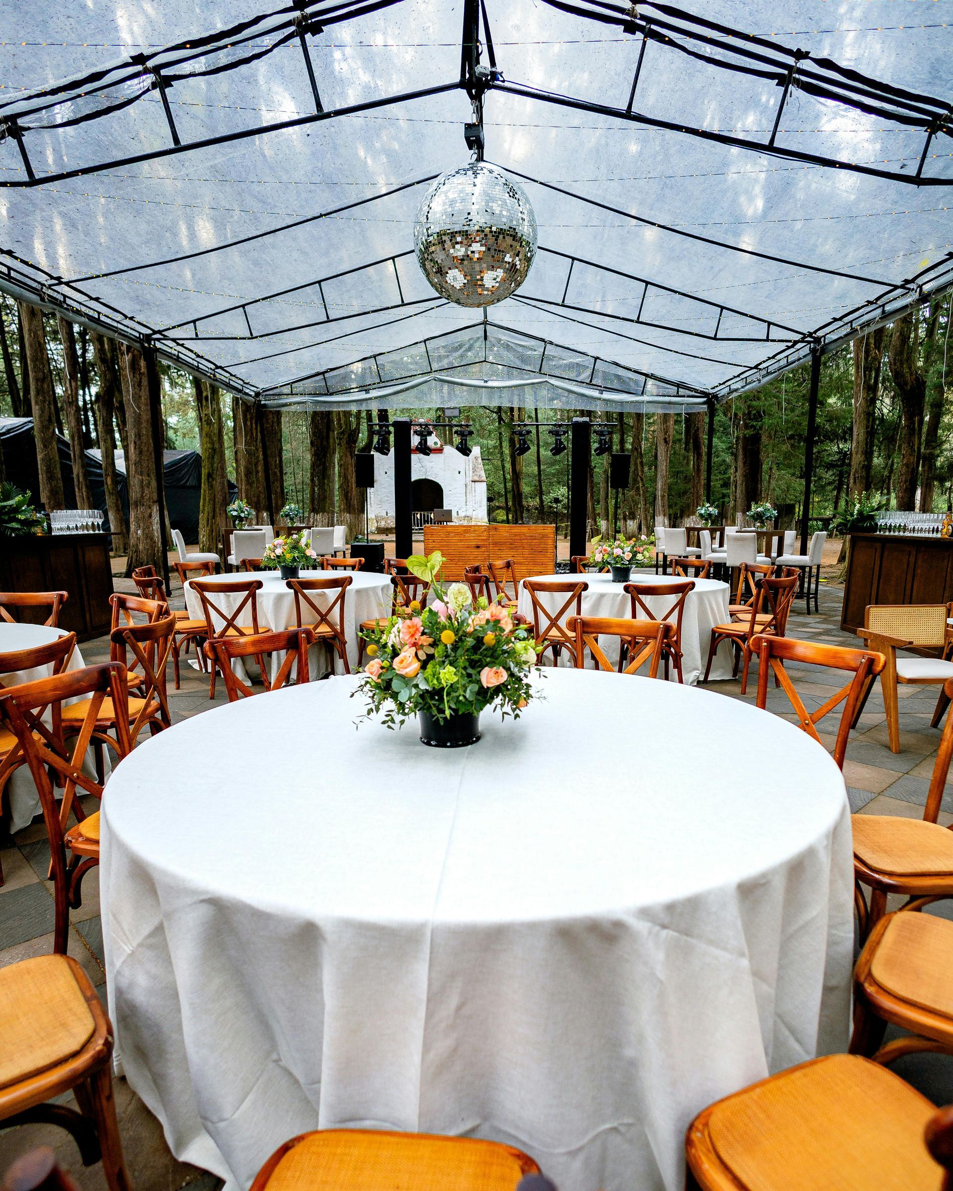 A round table with a vase of flowers on it