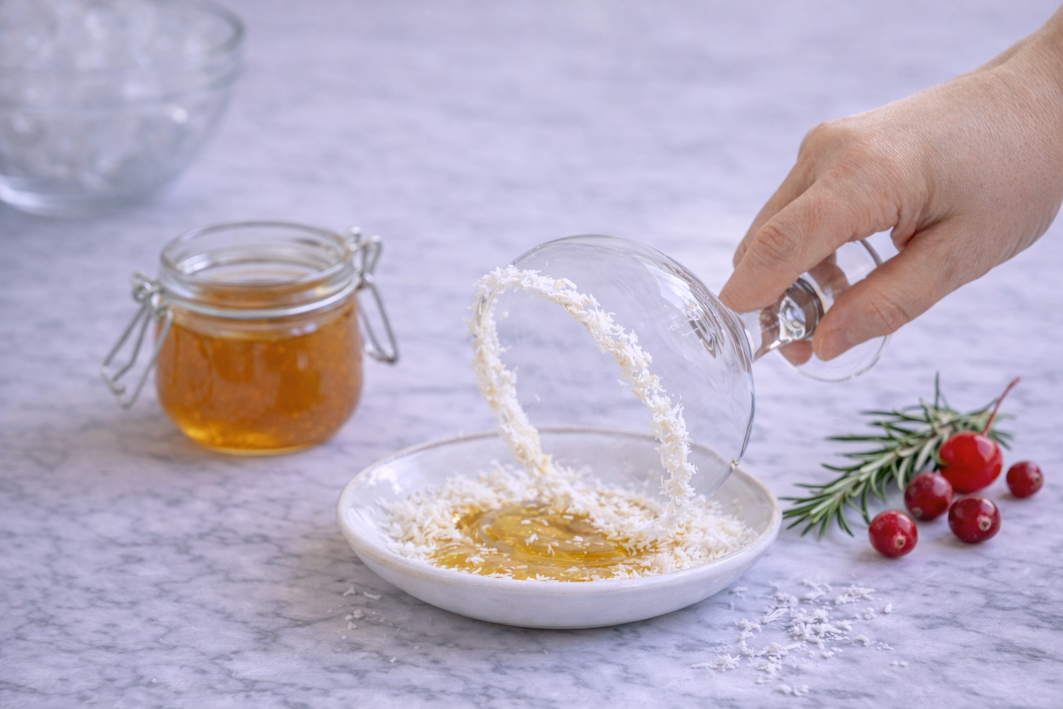 Glass rim coated with honey and dipped into shredded coconut to create a snow-like effect for a holiday mocktail.