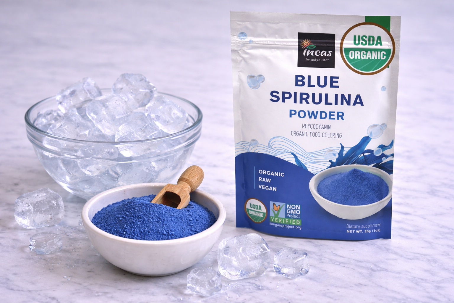 Ice and blue spirulina powder, optional ingredients for creating the icy blue color of a Jack Frost Christmas mocktail.