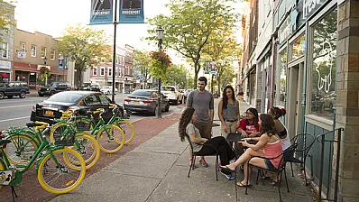 A group of people sitting outside a cafe