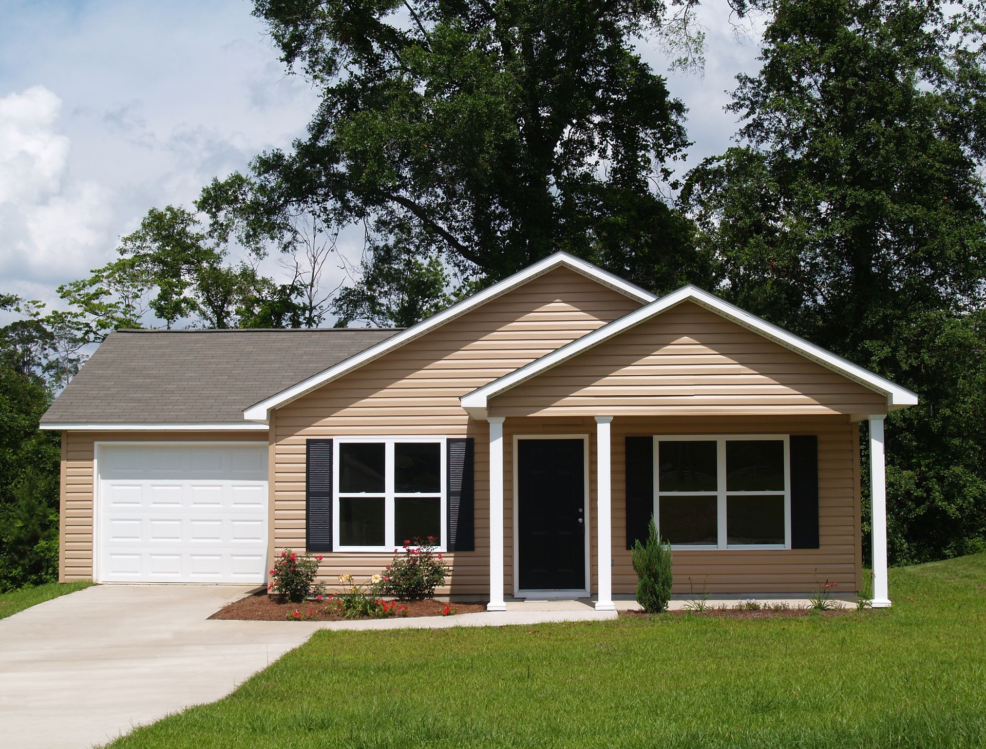 A house with a white garage door and black shutters