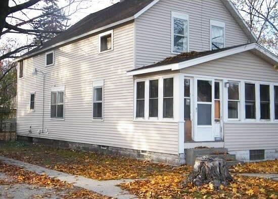 A house with a porch and a lot of windows