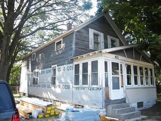 A house with a car parked in front of it