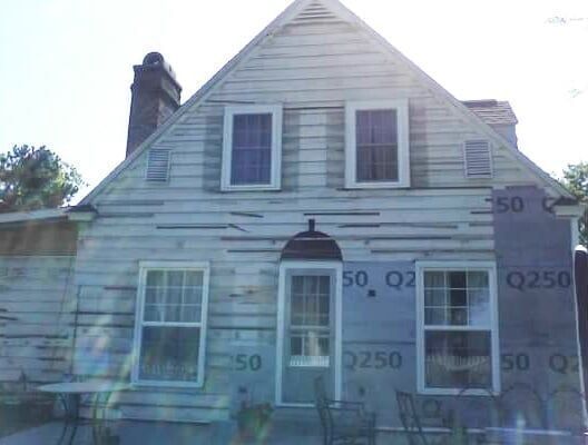 A white house with a roof that has the number 50 on it