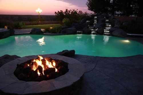 A fire pit in the middle of a swimming pool