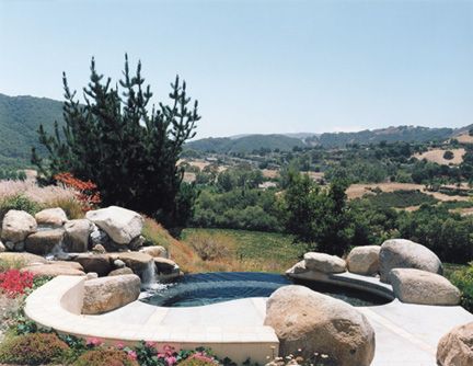 A hot tub with a view of a valley and mountains