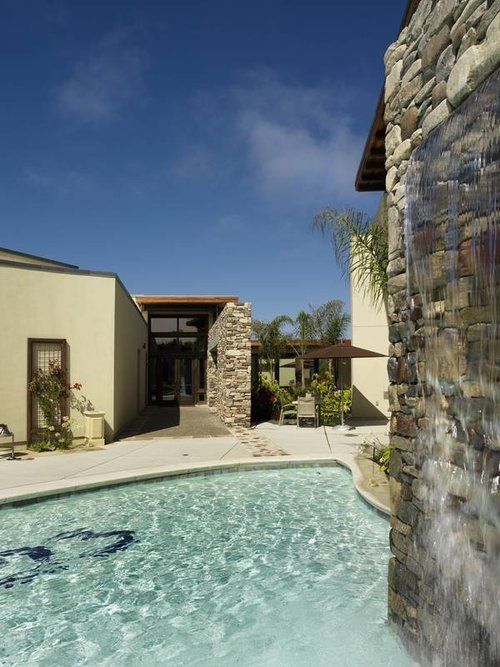 A swimming pool with a waterfall in the background