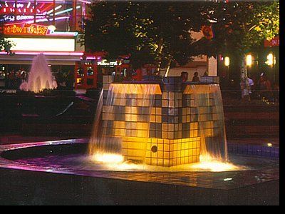 A fountain in front of a building with a sign that says ' a & w ' on it