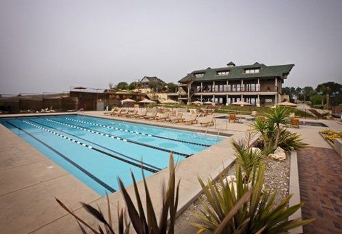 A large swimming pool in front of a large building