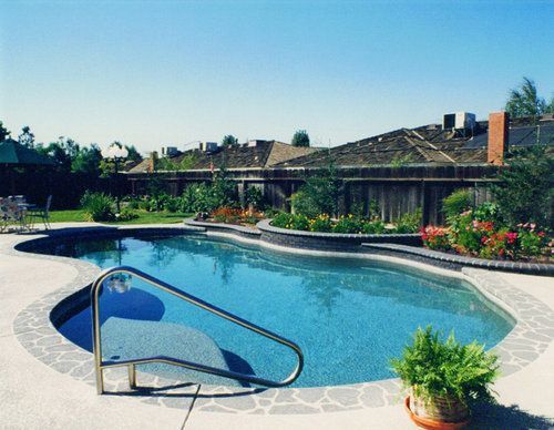 A large swimming pool with stairs leading to it