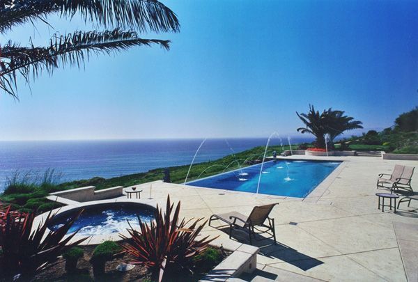 A large swimming pool with a view of the ocean