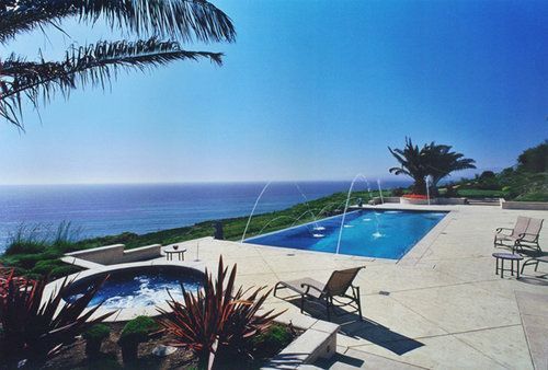 A large swimming pool with a view of the ocean