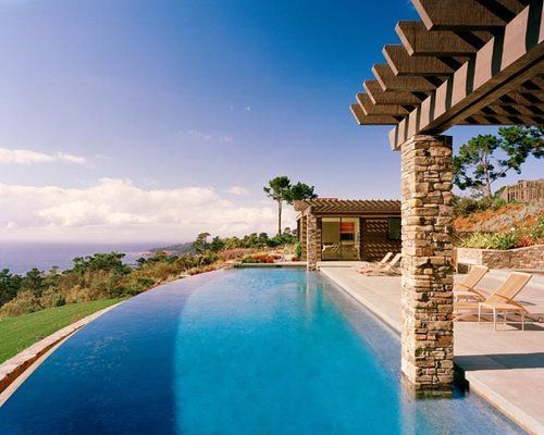 A large swimming pool with a view of the ocean