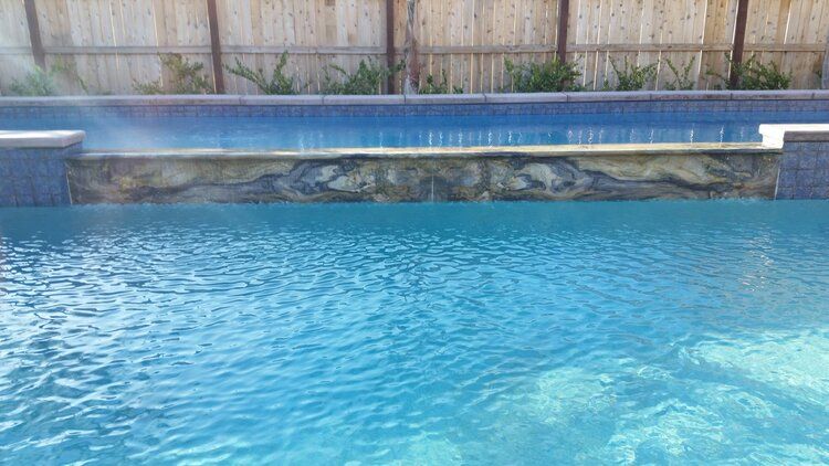 There is a waterfall in the middle of the pool.