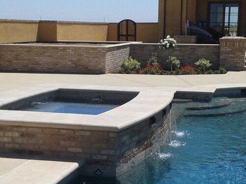 A large swimming pool with a hot tub in the middle