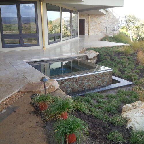 A large house with a swimming pool in front of it