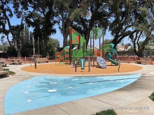 An artist 's impression of a playground in a park.