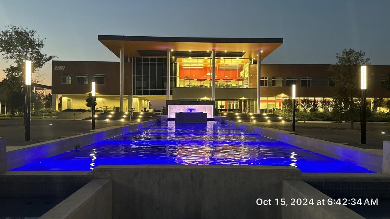 A large building with a fountain in front of it