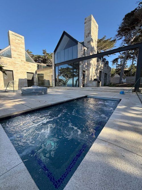 A large house with a swimming pool in front of it