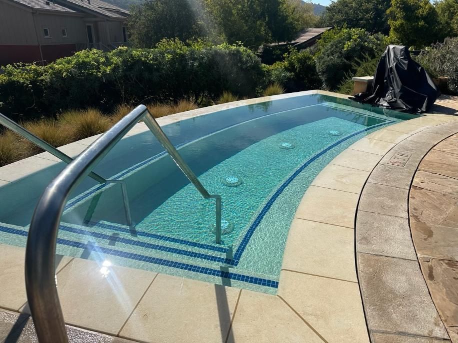 A large swimming pool with stairs leading to it