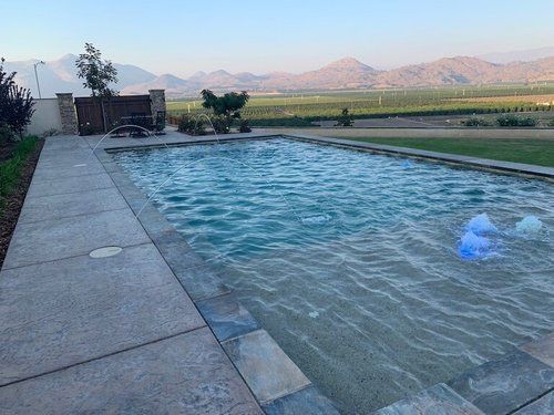 A large swimming pool with mountains in the background.