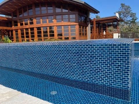 A large house with a swimming pool in front of it