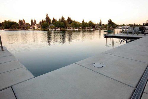 A large body of water with a dock in the foreground