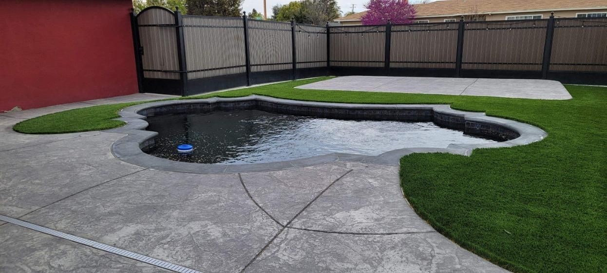 There is a small pool in the middle of the backyard.