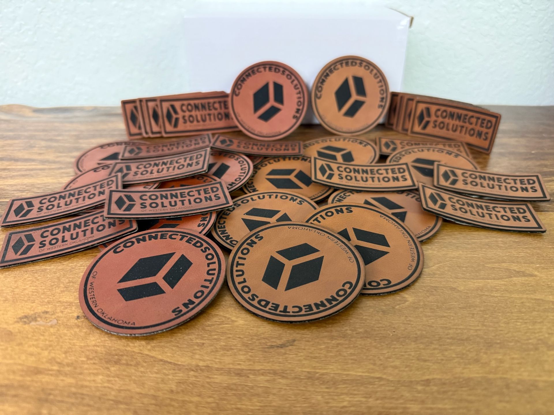 A pile of brown leather patches branded with the 