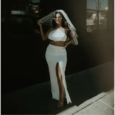 A beautiful woman in a bridal dress with spray tan near Dripping Springs, Texas
