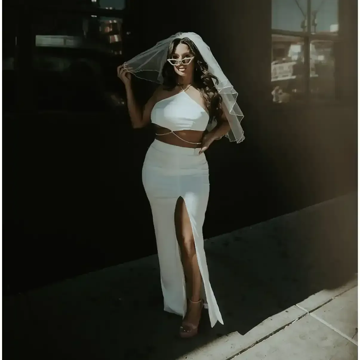 A beautiful woman in a bridal dress with spray tan near Dripping Springs, Texas