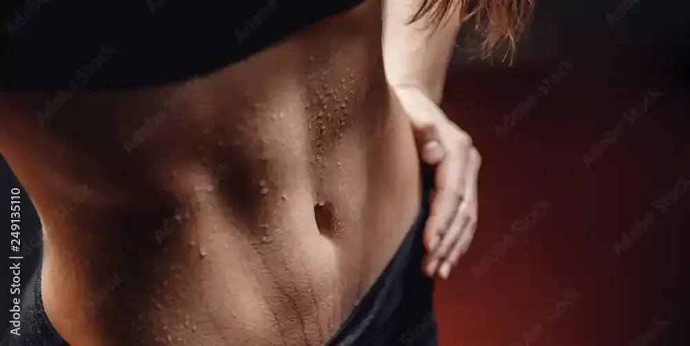 A woman showing off her sweat resistant spray tan near Austin, Texas