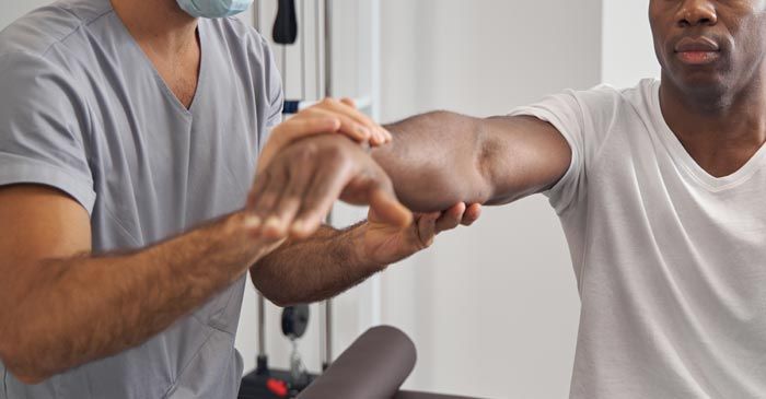 Man Getting Muscle Testing Treatment by Dr. Louis Granirer Holistic Chiropractor