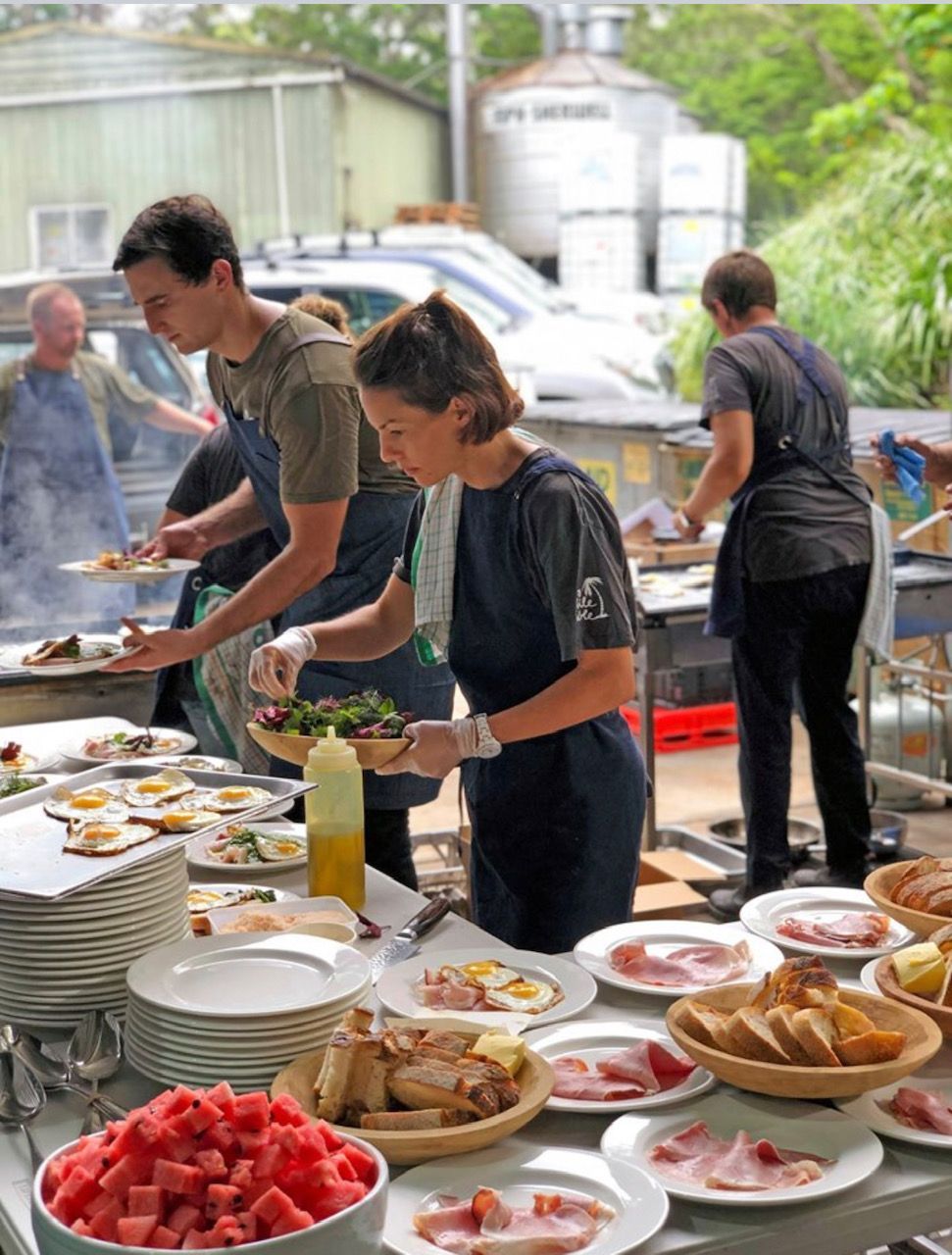 A group of people are preparing food on a table.