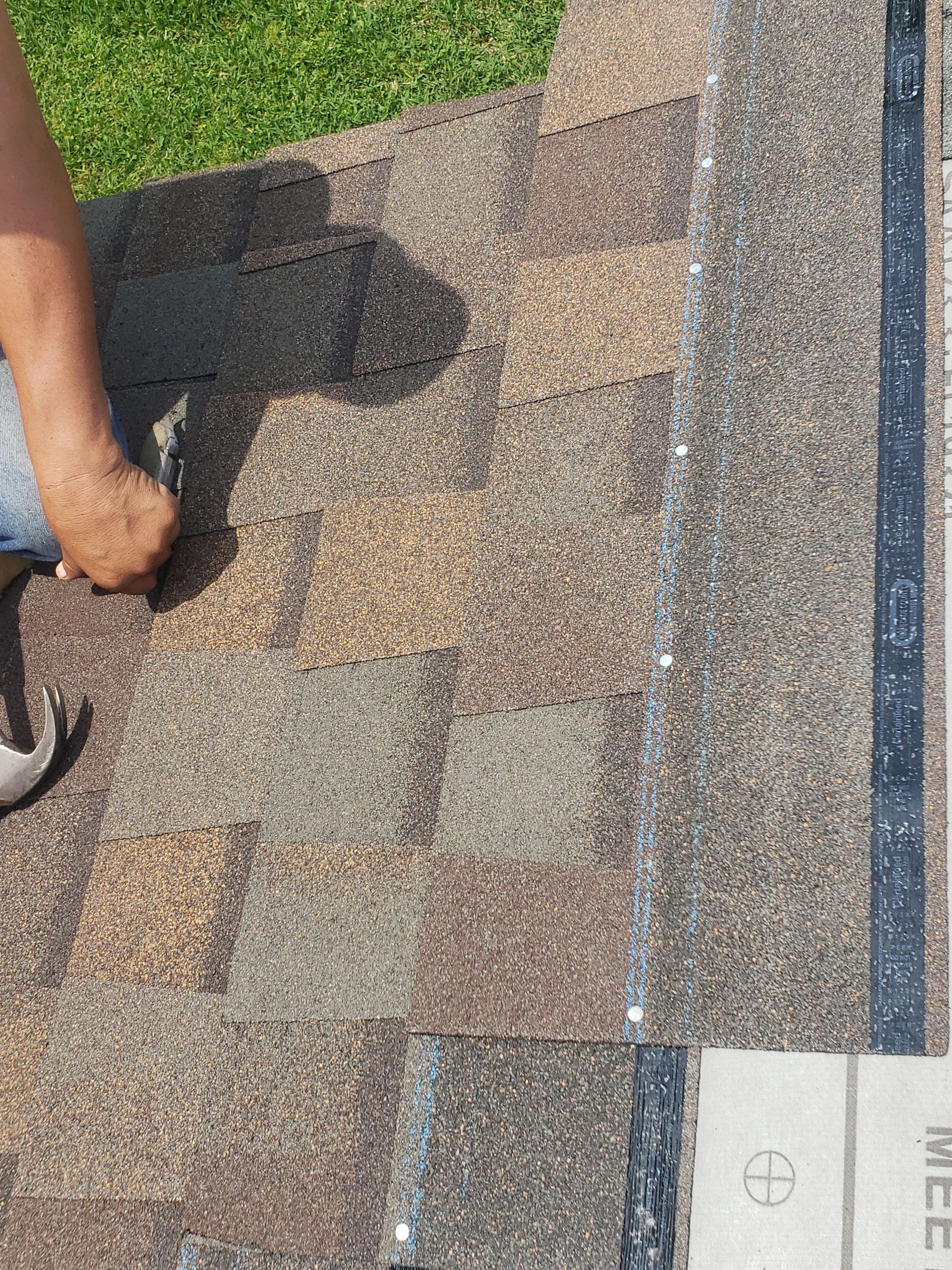 A person is working on a concrete surface with a hammer.